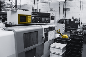 Obsolete industrial servo drive and motor unit in factory setting, representing Siemens Micromaster and Allen Bradley PowerFlex replacement solutions