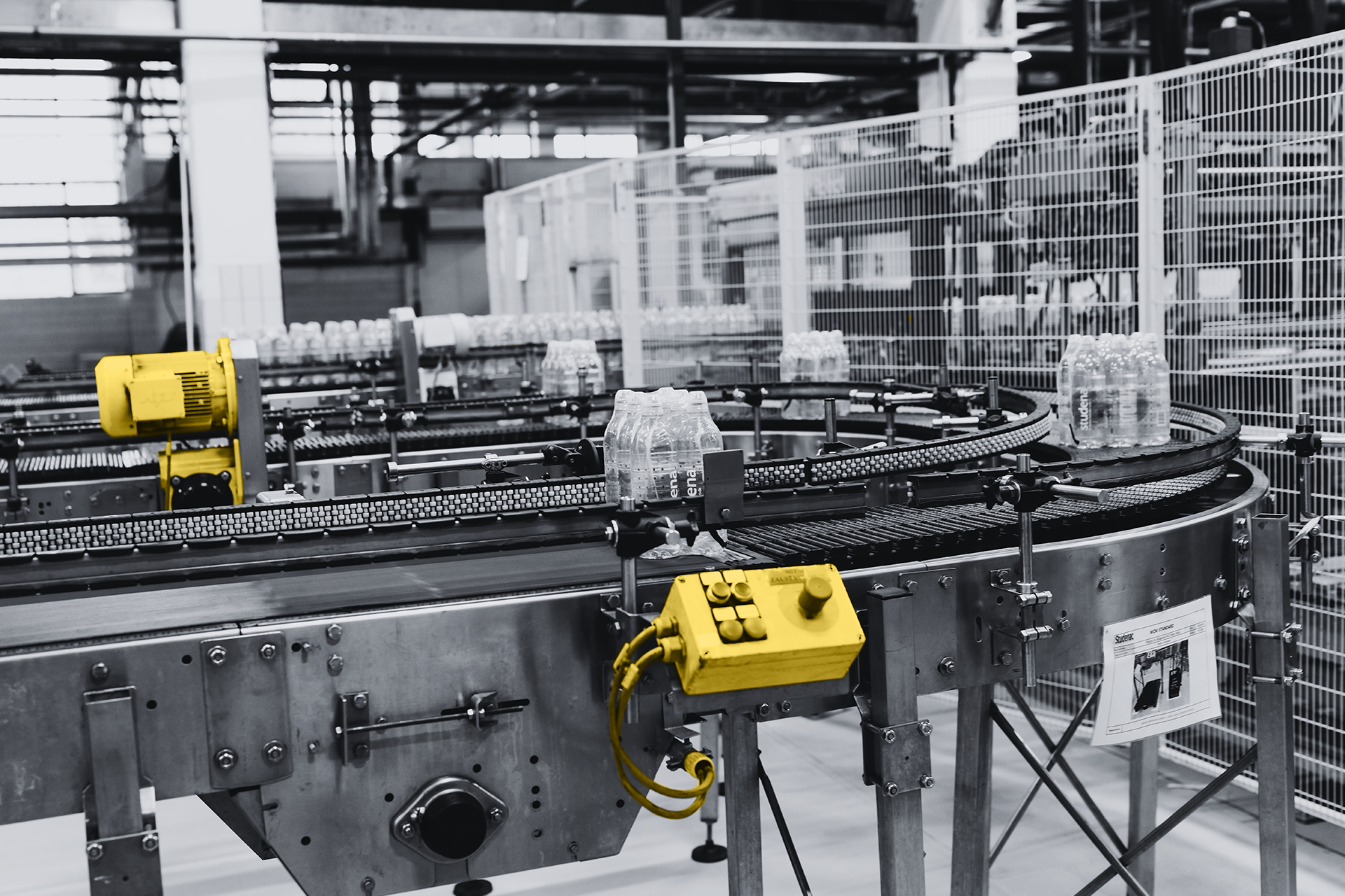 Food processing conveyor line with automated bottling system, representing obsolete Siemens and Allen Bradley automation spares preventing production downtime